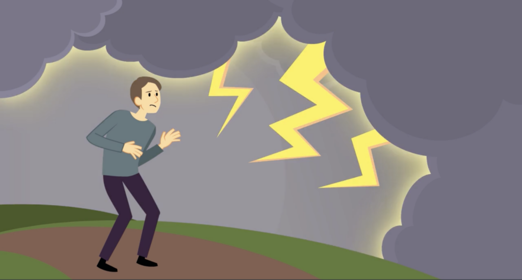 A man crouches down as lightning flashes from a dark cloud above him.